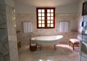white bathroom with three quarter length faux marble siding from floor